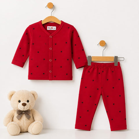 A baby clothing set consisting of a red long-sleeve cardigan and matching red pants, both decorated with small black star patterns. The cardigan is shown hanging on a wooden hanger, and the pants are shown hanging on a metal hanger.