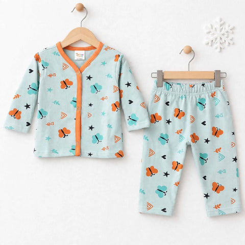 A baby two-piece pajama set consisting of a long-sleeve cardigan and matching pants, displayed on wooden hangers against a white wall. The pajamas feature a light mint green base with a colorful cartoon pattern of orange butterflies, teal birds, and black stars, accented by orange trim.