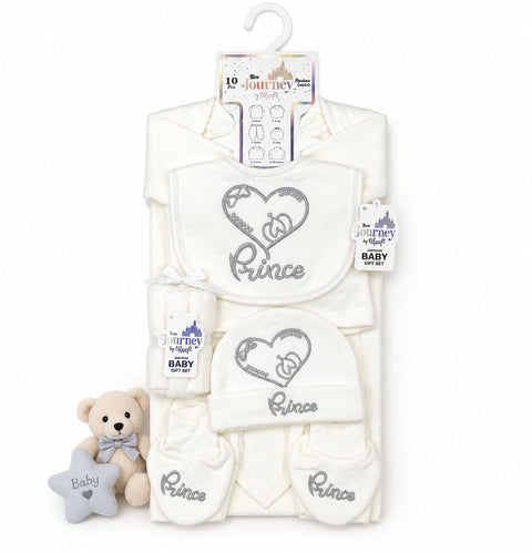 A baby gift set featuring a white long-sleeve onesie, two bibs, a hat, and booties with gray embroidered 'Prince' and heart designs, displayed on a hanger with a small teddy bear and star toy.