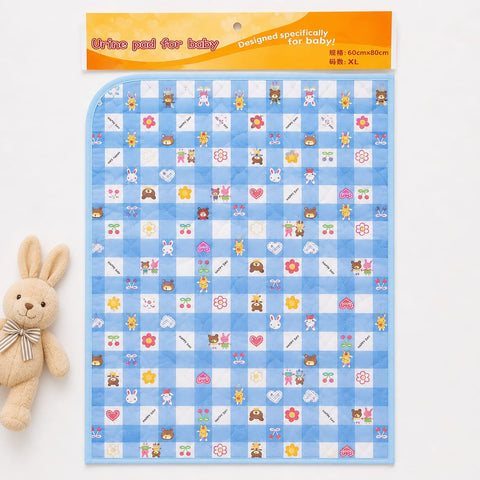 A packaged baby urine pad set with a light blue and white checkered pattern featuring cute cartoon animal and flower motifs. The product is shown with its orange header card packaging, alongside a small plush bunny toy on a clean white background.