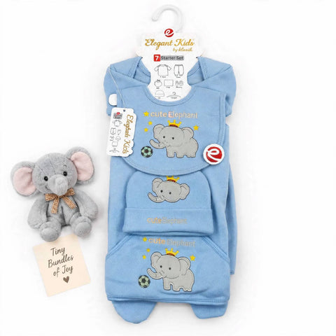A light blue 3-piece baby outfit set with elephant prints, displayed on a hanger next to a small plush elephant toy and a card reading 'Tiny Bundles of Joy'.