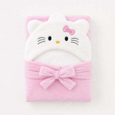 A folded pink plush bath towel featuring an embroidered Hello Kitty face on the hood and a large bow around the middle, shown on a clean white background.