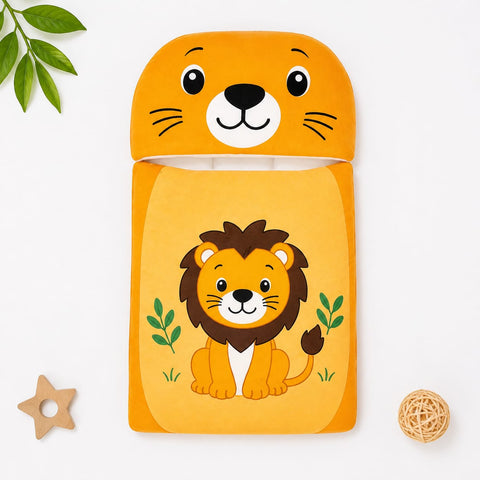 A children's soft fabric pouch or case with a lion face on the top flap and a lion illustration on the front, shown in a styled flat-lay on a white background with small decorative props.