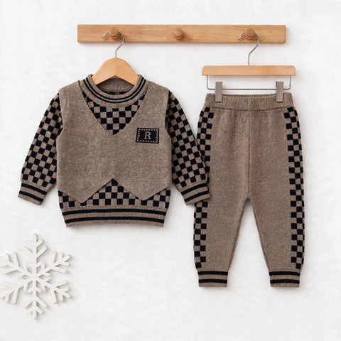 A toddler boy's two-piece knit outfit set consisting of a long-sleeve sweater vest and matching pants, displayed on wooden hangers against a white wall. The set features a taupe-brown vest with black and white checkered patterns on the sleeves, collar, and hem, and matching checkered side panels on the pants.